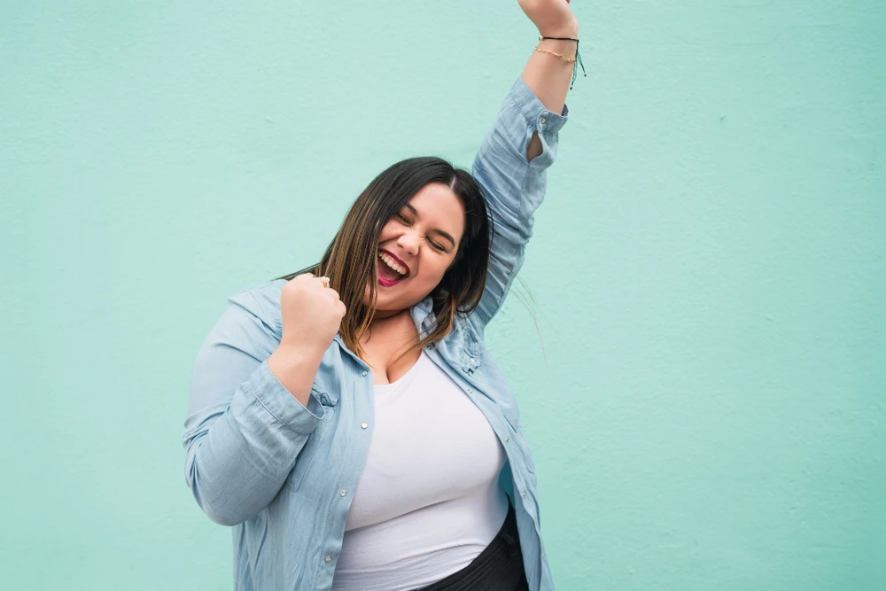 Woman celebrating during a 21 Day Online Fitness Class Challenge